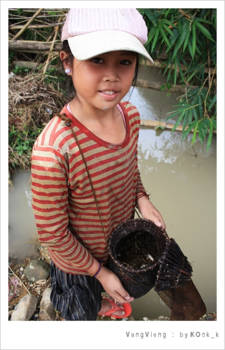 Laos - Laos girl proudly showing her catch