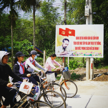Vietnam - Vietnamese kids going to school and Uncle Ho is watching.