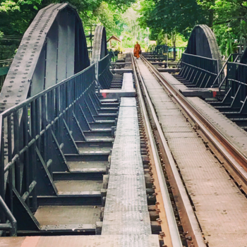 Thailand - A thaimonk at the impressie bridge on the Rober Kwai